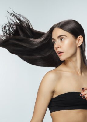 beautiful-model-with-long-smooth-flying-brunette-hair-isolated-white-studio-background